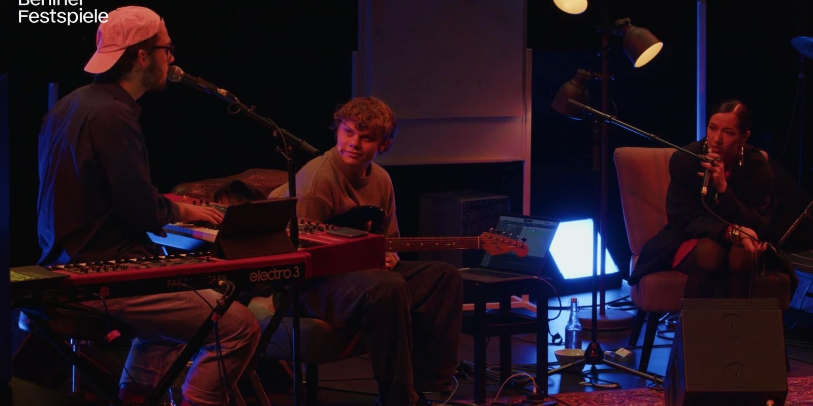 Three people make music.