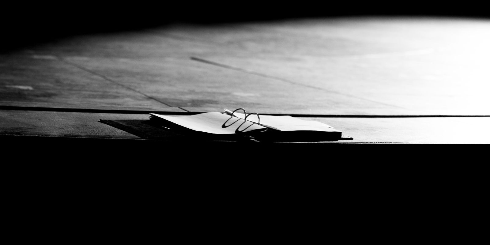 An open binder on an empty stage.