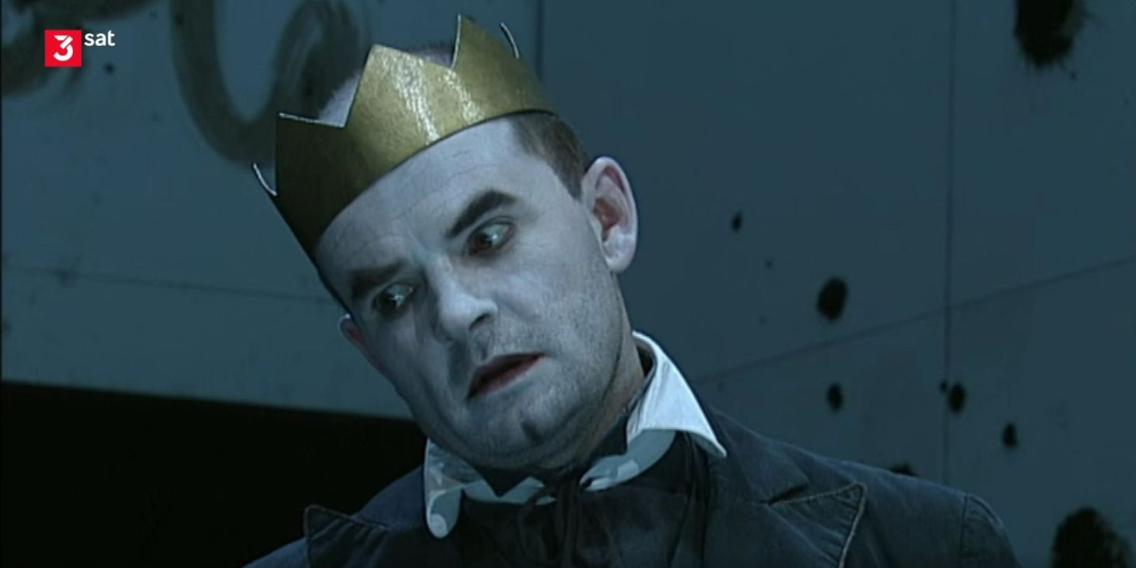 A man wears a golden crown.