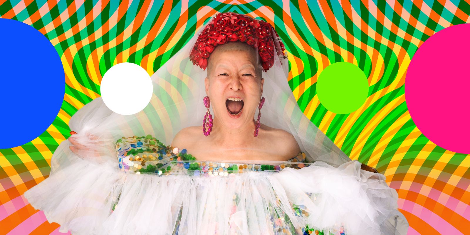 Eun-Me Ahn screams. She wears a headdress made of flowers and a colourful dress with tulle.